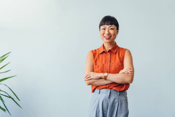 istock Confident ASIAN Woman Smiling in Bright Office Environment 2175497388