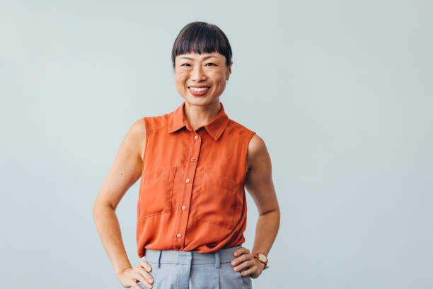 Confident ASIAN Woman Smiling in Bright Office Environment