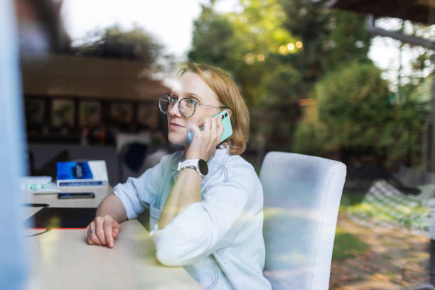 istock Mid adult woman working from home using mobile 2175502711
