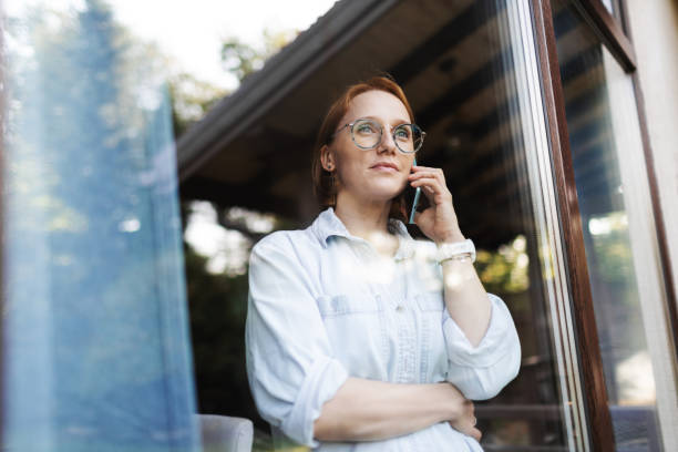 Mid adult woman talking by mobile