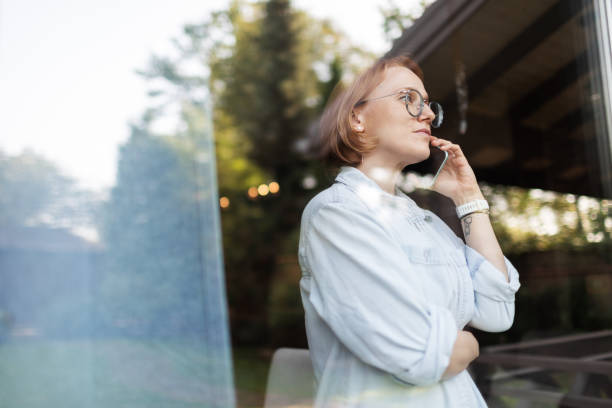istock Mid adult woman talking by mobile 2175502904