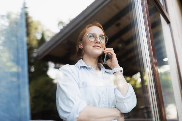 istock Mid adult woman talking by mobile 2175502930