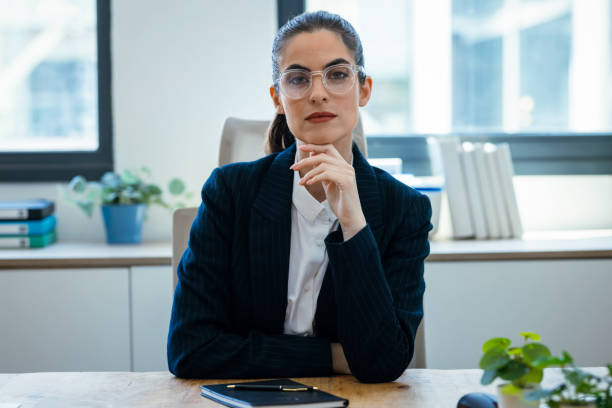 istock Confident business woman speaking through the webcam while making a video conference from the office 2175504524