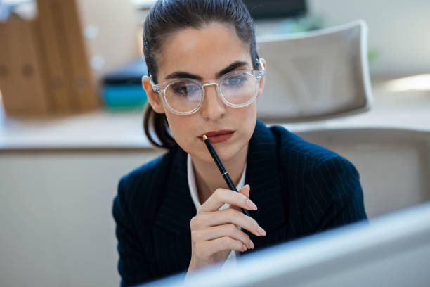 istock Concentrated beautiful business woman working with computer at the office 2175504552