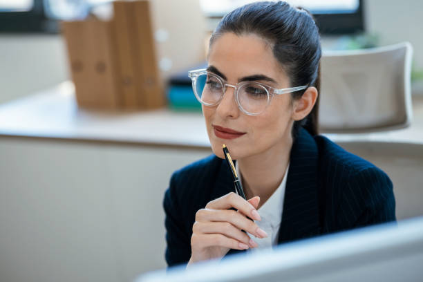 istock Concentrated beautiful business woman working with computer at the office 2175504559