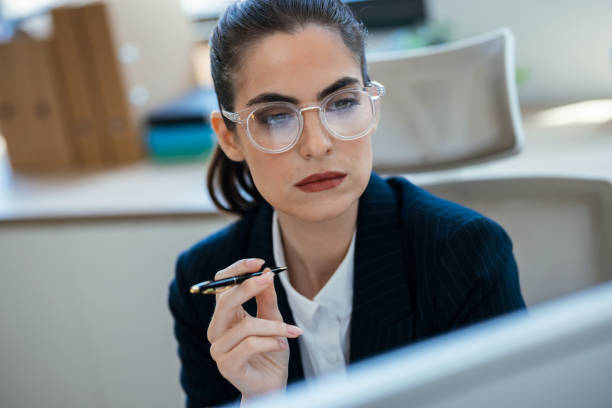 istock Concentrated beautiful business woman working with computer at the office 2175504563