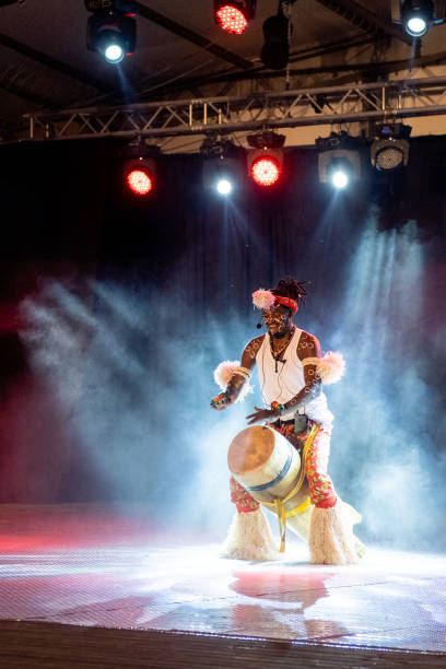 istock An African performer of authentic African rhythms performs on stage. 2175506910