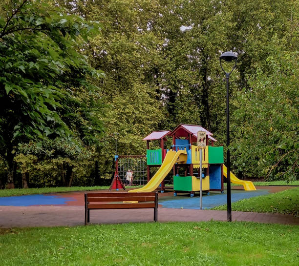 istock Childcares playground surrounded by green trees 2175509539