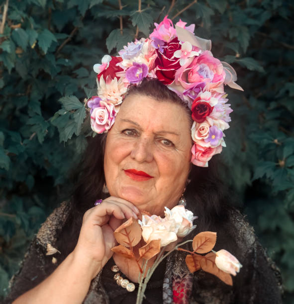 Senio lady in garden wearing flower headdress
