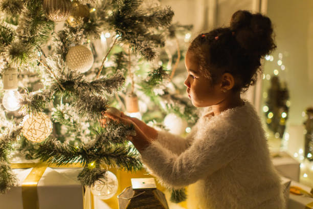istock Girl decorating Christmas tree. 2175512042