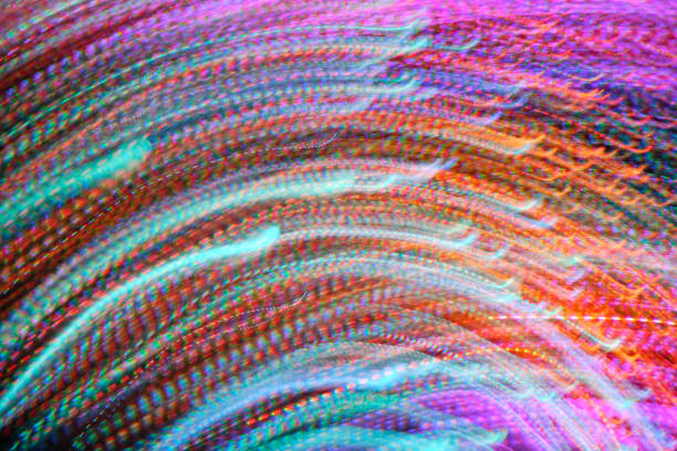Red, white and yellow light trails on a black background.