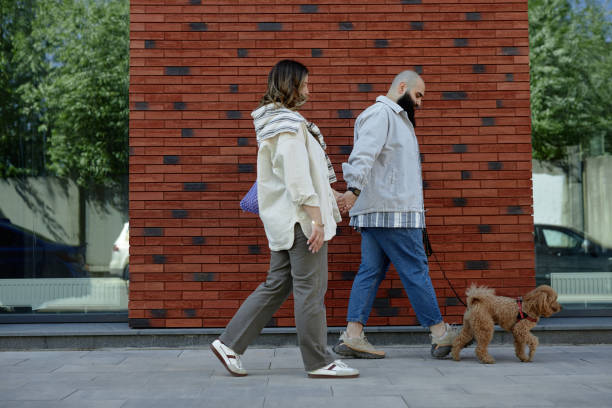 istock Strolling on City Sidewalk with Small Dog in Tow 2175516471