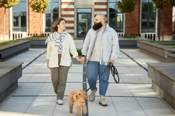 istock Walking Together Holding Hands with Their Dog Crosby 2175516473