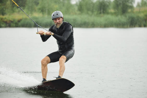 istock Bearded Man Wakeboarding on Lake Waters Moving Towards Camera 2175517043