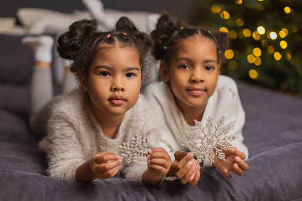 Two girls having fun on bed. Christmas