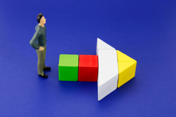 istock Executive following route marked with arrow formed with colorful wooden figures 2175518091