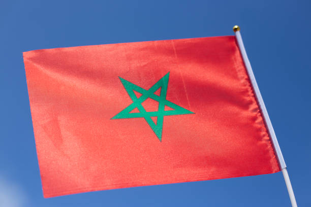tiny Moroccan Flag against blue sky , Kingdom of Morocco Flag