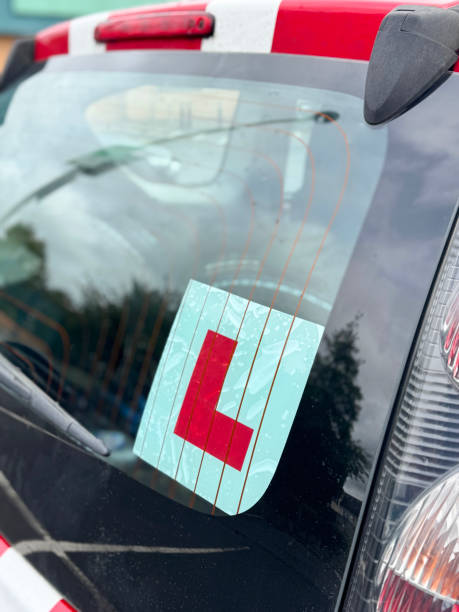 istock Image of learner driver car with l-plate clearly displayed on windshield / a sign of excitement and growth as new drivers 2175520715
