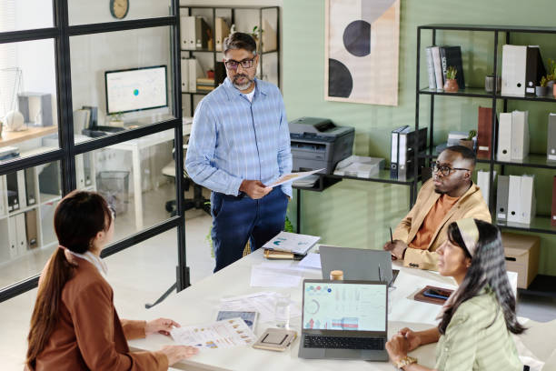 istock Holding Document While Leading Business Meeting in Modern Office 2175521808