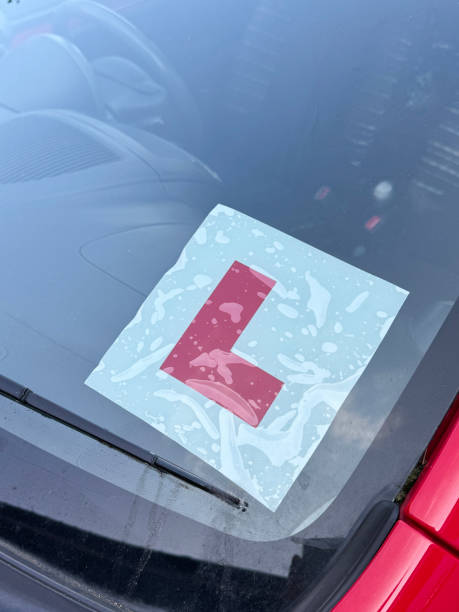 istock Image of vehicle with l-plate displayed on windshield signifying a learner driver / representing the exhilarating experience of mastering driving skills 2175521936