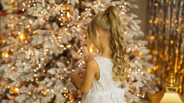 istock Girl decorating Christmas tree 2175524482