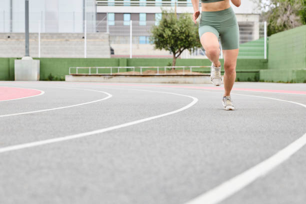 istock Young woman running on an athletics track 2175528375