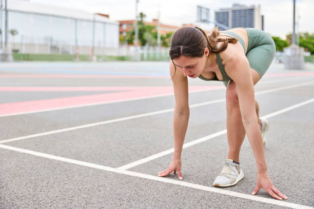 istock Determined female athlete preparing for a run on a running track 2175528382