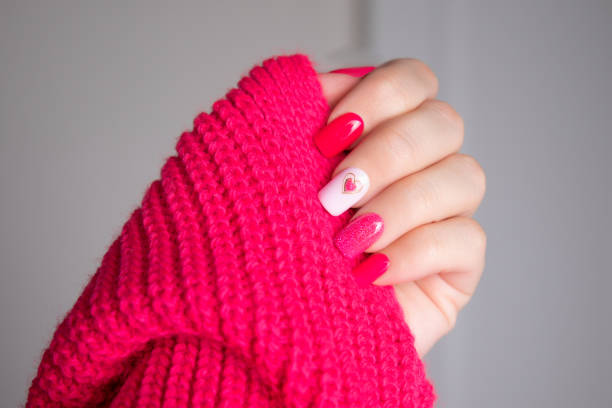 istock Female hand with pink manicure nails, heart design 2175529364
