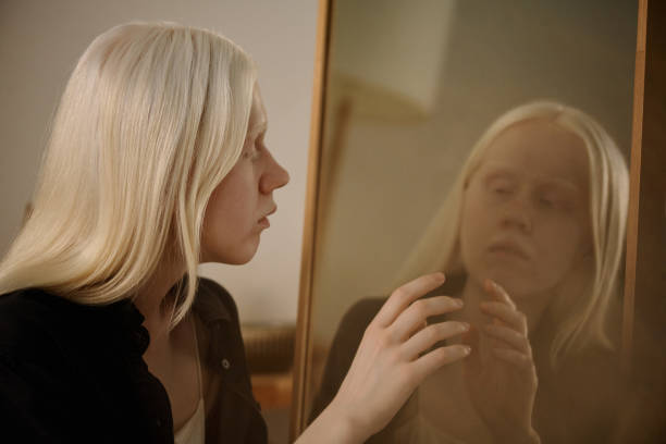 istock Young Woman Touching Mirror Image 2175529860