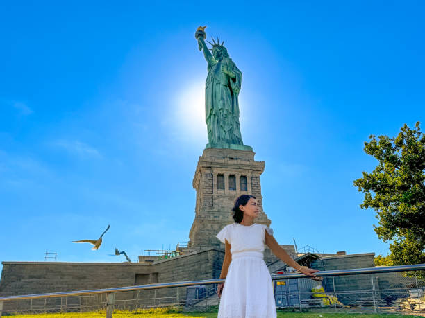 istock Statue of Liberty under blue sky with a bird 2175530722
