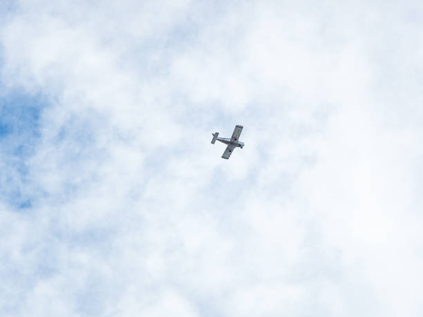 istock Small ultralight airplane with overhead wing and single propeller flying in sunset sky. 2175530731