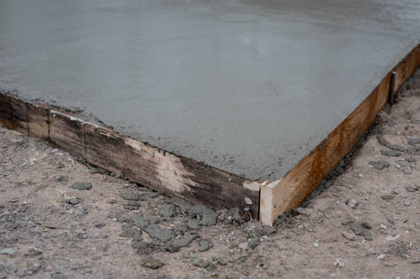 istock wet concrete pouring into wooden frame 2175530862