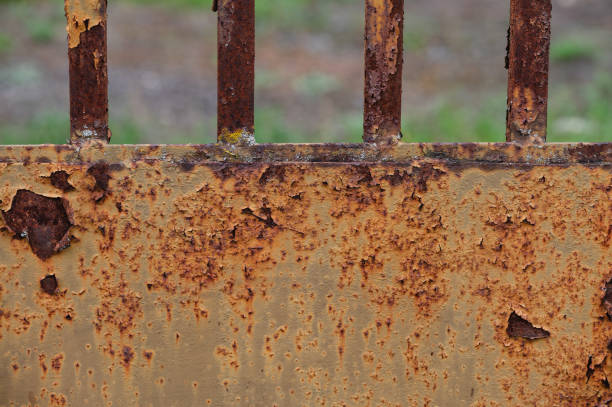 istock Rusty metal fence with green foliage background 2175531705