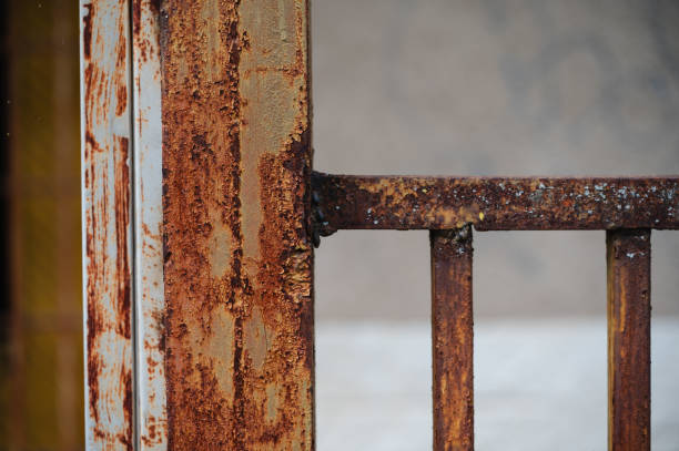 istock Rusty metal fence with green foliage background 2175531712