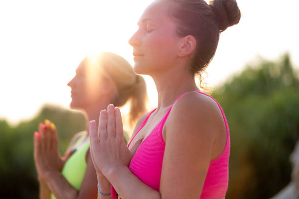 istock two women are meditating outside in nature 2175533252