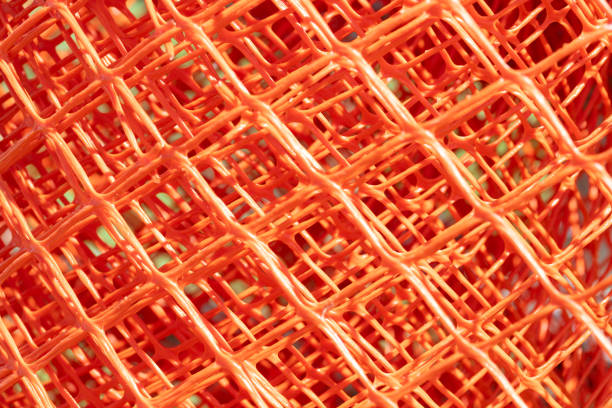 close up of orange net plastic fence