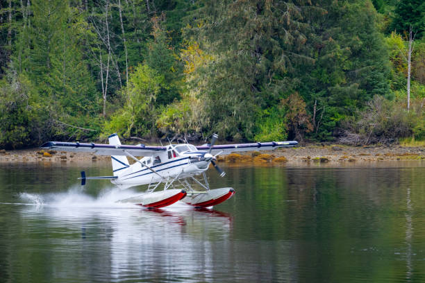 Float plane landing in Coal Harbour, Vancouver Island, BC Canada
