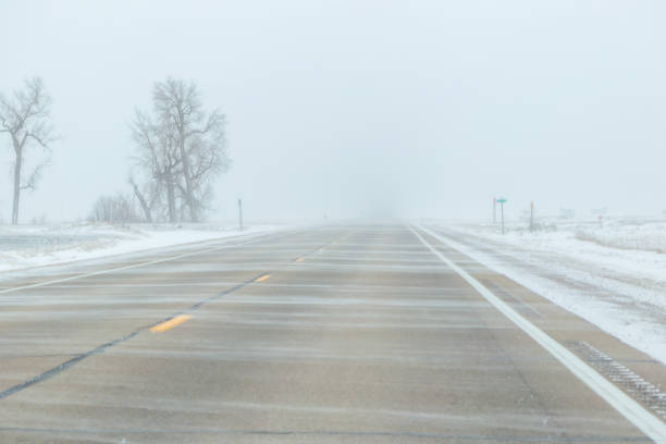 istock Blowing Snow on Highway in Winter 2175537512