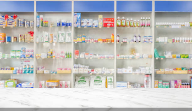 istock Empty white marble counter top with blur pharmacy drugstore shelves background 2175540810