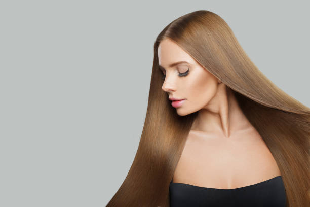 istock Gorgeous young woman model with modern make-up and long straight smooth hairstyle standing on white studio background 2175541376