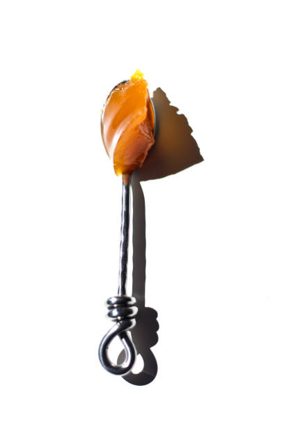 Sunlit Apricot/Peach Jam on Spoon, White Background
