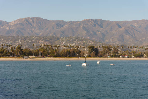 istock Water body with mountains behind and boats in front 2175548973