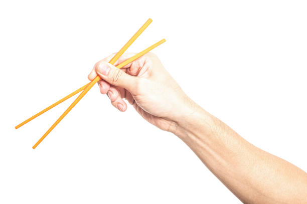 istock Male hand holding a orange plastic chopstick isolated on white background. 2175549080