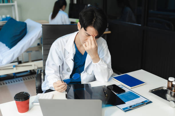 istock Medical students eyestrain fatigued from computer work, stressed man overworked with fatigue sit at office table using laptop. 2175557004