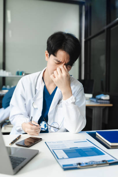 istock Medical students eyestrain fatigued from computer work, stressed man overworked with fatigue sit at office table using laptop. 2175557007