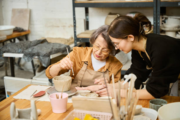 istock Sweet old lady is engaged in creativity in the workshop 2175557610