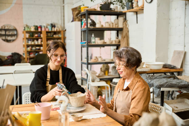 istock Female potter uses a spray gun 2175557627