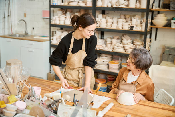 istock Young female works with a rolled out layer of clay 2175557663