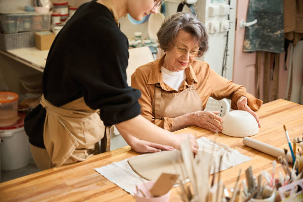 istock Young female holds a rolled out layer of clay 2175557672