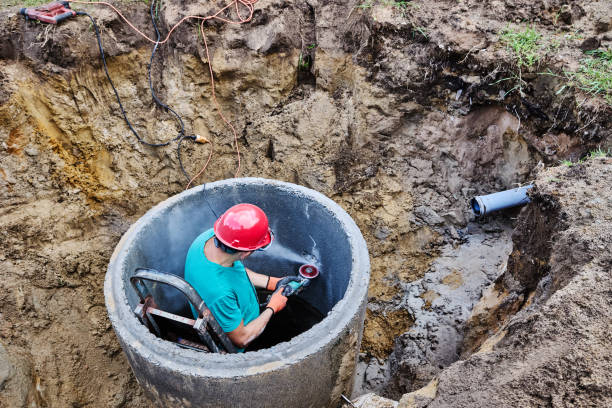 istock Installing concrete ring septic tank for waste water with diamond ring sawing with help of which hole is cut for sewer pipe. 2175559173